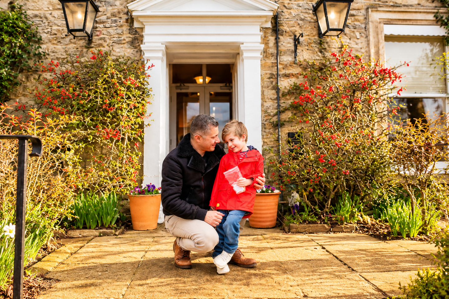 Father and son sharing a moment outside the stone entrance of The Burgoyne Hotel.