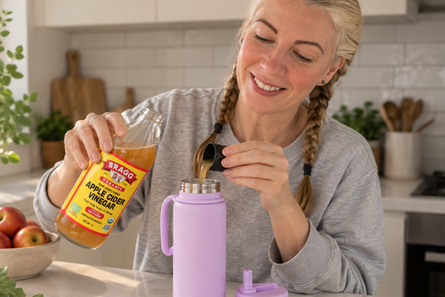 Saffron adds apple cider vinegar to her water bottle