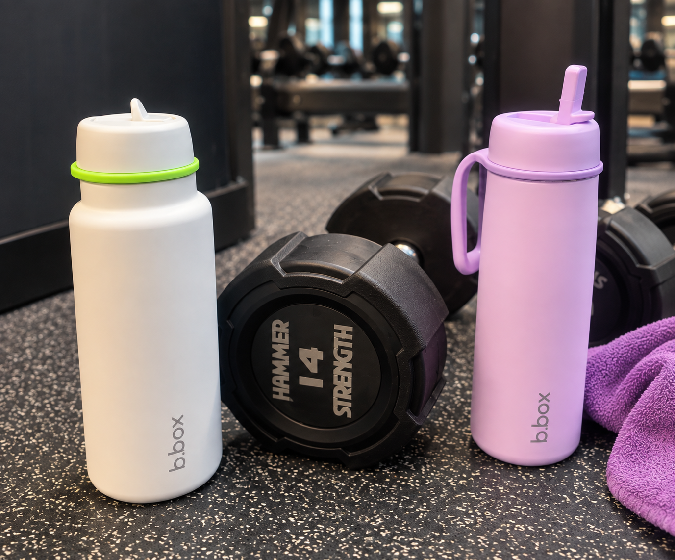 Gym water bottle beside dumbbells during a midlife strength workout